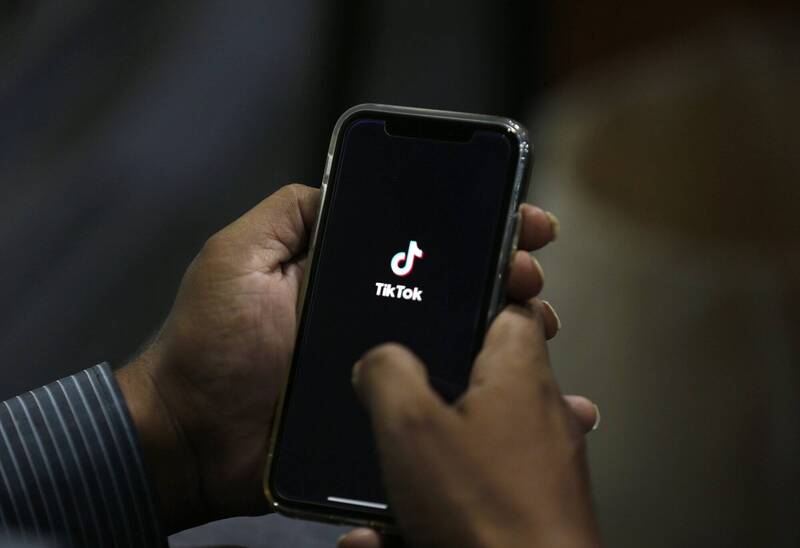 图为巴基斯坦一名男子正在打开短影音平台「TikTok」。（美联社）