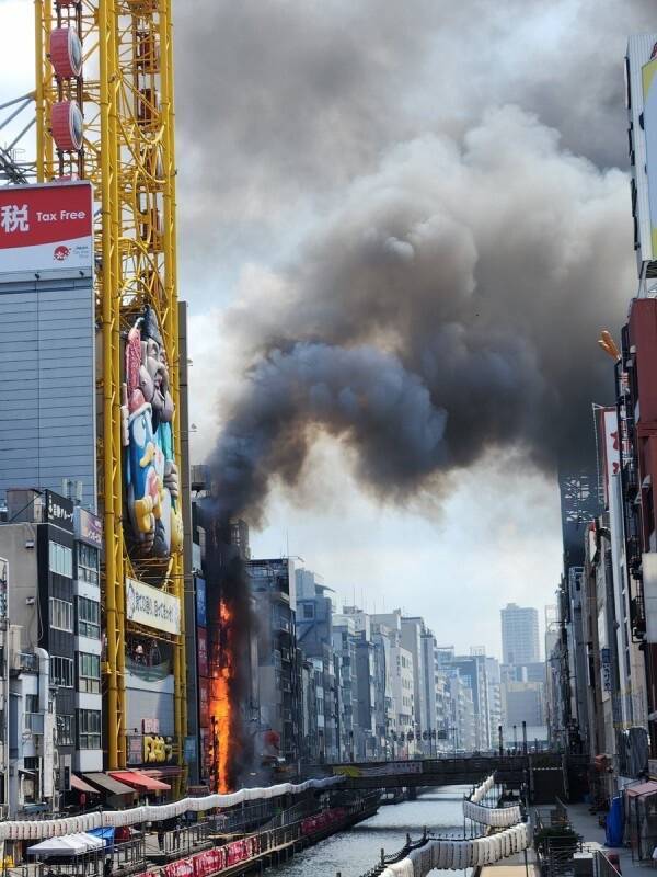 大阪道顿堀运河旁的一栋建筑物失火，冒出阵阵浓烟。（图撷取自社群媒体「X」）
